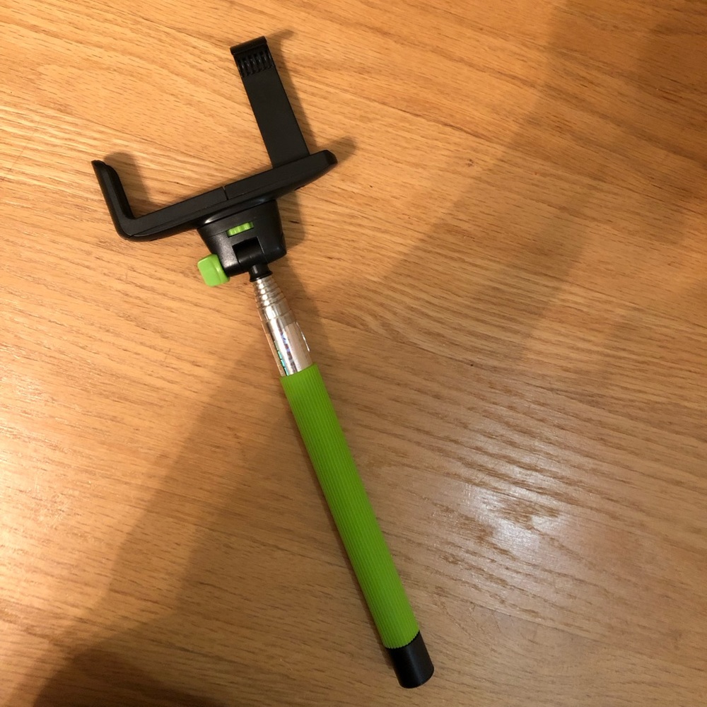 Green selfie stick with charger